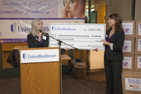 Anastacia Snyder (right), executive director of Catalyst Domestic Violence Services, accepts check from Pam Jamian, site director of UnitedHealthcare's Chico Operations Center, on Thursday, Oct. 1. The $3,000 donation, along with a donation of 4,100 pounds of food and personal hygiene items, marks the beginning of a month-long public service campaign in partnership with Catalyst Domestic Violence Services, Chico Chamber of Commerce and the local business community to raise awareness during October, which is Domestic Violence Awareness Month (Photo: Brian Peterson).