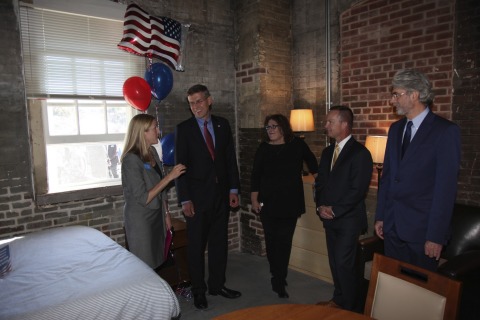 Key project partners, Congressman Erik Paulsen and newly moved-in veteran/resident Judy Ganino receive a tour of one of the 58 new apartments at Upper Post Veterans Community. Developed by CommonBond Communities, the new property provides new homes and support services for veterans struggling with homelessness. UnitedHealth Group was the largest investor in the project, providing $9.3 million in equity. L to R: Deidre Schmidt, president and CEO of CommonBond Communities; Congressman Paulsen; veteran/resident Judy Ganino; Tom Wiffler, chief operating officer, UnitedHealthcare Military & Veterans; and Warren Hanson, president and CEO of Greater Minnesota Housing Fund & MEF (Photo: Greg Page).