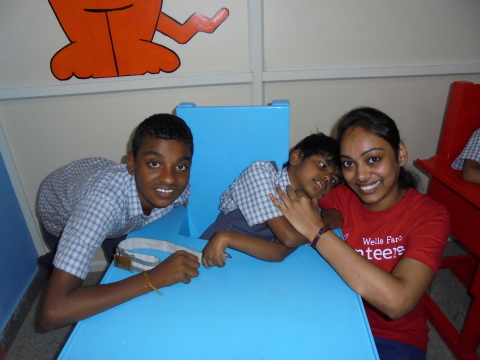 A Wells Fargo volunteer putting a smile on the faces of children with physical challenges at Samarthanam Trust, a non-profit organization that works for the differently-abled in Bengaluru. (Photo: Business Wire)