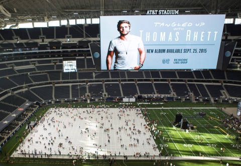 Singer Thomas Rhett and his fans take part in a huge TWISTER game on the World Record Breaking TWISTER mat which measures 27,159.616 square feet, at AT&T Stadium in Arlington, TX on Wednesday, September 29, 2015. (Photo: Business Wire)