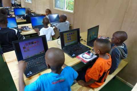 The children of the Tuleeni Orphanage working on the computers in their new mobile classroom. (Photo: Business Wire)