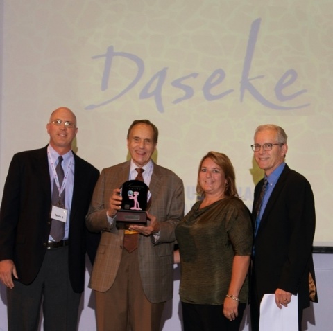 Daseke CEO Don Daseke (second from left) accepts the Owens Corning supplier of the year award in its "sustainability" category from Owens Corning executives at the company's annual supplier recognition event. Owens Corning works with a supplier base exceeding 10,000 worldwide, and Daseke was the only trucking company honored with an award. From left to right are: Tony Heldreth, vice president of supply chain; Daseke; Amy Mielke, transportation sourcing leader; and Frank O'Brien-Bernini, vice president and chief sustainability officer. (Photo: Business Wire) 