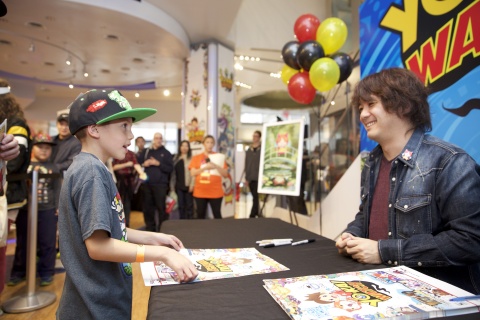 In this photo provided by Nintendo of America, Founder, President/CEO of LEVEL-5 Inc. Akihiro Hino signs autographs and poses for pictures with fans at the launch of the YO-KAI WATCH video game for the Nintendo 3DS family of systems at Nintendo World in New York on Nov. 7, 2015.