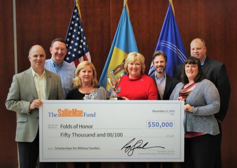 Sallie Mae donates $50,000 to Folds of Honor to fund scholarships for spouses and dependent children of servicemembers killed or disabled in active duty. Pictured at Sallie Mae’s Newark, Del., headquarters are, left to right: Tim Hanrahan, senior vice president, Sallie Mae; Daniel Kennedy, U.S. Army veteran and senior vice president and chief information officer, Sallie Mae; Susan Dorris, Folds of Honor representative; Gail Wronowksi, Folds of Honor representative; Eric Chas, U.S. Marine Corps veteran and senior director, Sallie Mae; January Kendall, U.S. Army National Guard veteran and education coordinator, Sallie Mae; and Michael Hewitt, U.S. Air Force veteran and director, Sallie Mae. (Photo: Business Wire)