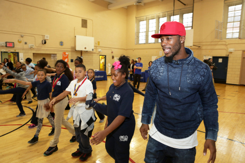 Dominique Rodgers-Cromartie of the New York Giants and founder of Dreambuilders New York (left) took a group of fourth graders from PS 15 through a series of warm-up exercises at a kick-off event today for his "food for children" initiative. Through Dreambuilders, Blessings in a Backpack and UnitedHealthcare, more than 250 in-need children at PS 15 in Manhattan, and PS 502 and PS 102 in Brooklyn will receive backpacks of healthy foods and snacks to take home over the weekends, when they may not otherwise have access to nutritious meals (Photo: Gerard Gaskin).