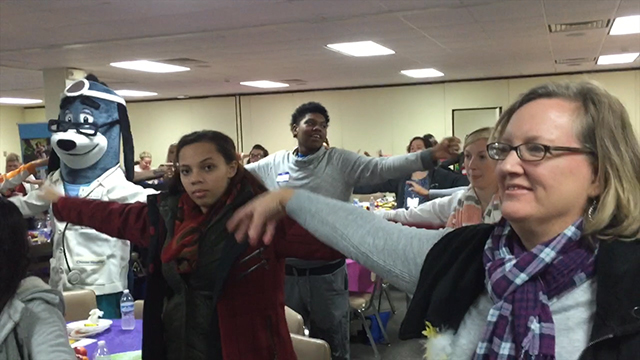 UnitedHealthcare mascot Dr. Health E. Hound leads a group of teen moms and moms-to-be in healthy exercises at the 15th annual Teaching Teens Outstanding Parenting Skills (T-TOPS) conference at the Central Baptist Bearden church in Knoxville, Tenn. UnitedHealthcare representatives gave a special lunchtime presentation on UnitedHealthcare’s Healthy First Steps case management program and Baby Blocks, an award-winning, free online wellness-incentive program. (Video Credit: Espe Greenwood)