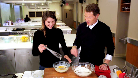 Chef Bobby Flay and his daughter, Sophie, cook together in videos Scripps Lifestyle Studios produced for Food Network’s Snapchat Discover channel. Here they are making one of her must-haves, chocolate chip pancakes. This video will debut December 16 with others to follow through mid-January. (Photo: Business Wire)