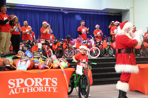 Sports Authority and the USS Foundation Surprise 100 Denver Children with Bikes and Helmets. (Photo: Business Wire)