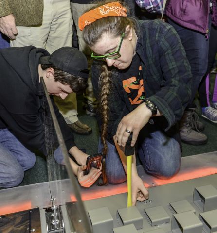 Students takes measurements of the playing field following the reveal of the 2016 FIRST® Robotics Competition FIRST STRONGHOLD game. (Photo: Business Wire)