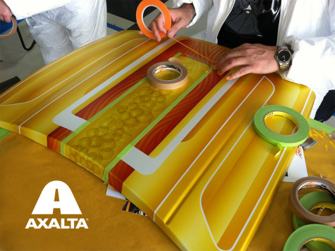 Artists in action preparing a hood for pinstriping - the art of applying very thin lines of paint to decorate a surface or create special graphics most commonly found on automobile and motorcycle bodies. (Photo: Axalta)