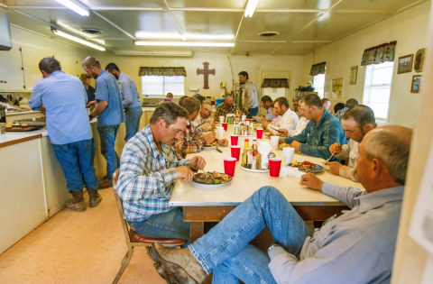 Waggoner Ranch Manager Weldon Hawley and Wagon Boss Jimbo Glover wait to eat lunch until everyone else has filled his plate - including ranch workers who aren't cowboys. ("Cowboys of the Waggoner Ranch" photography book by Jeremy Enlow.) 