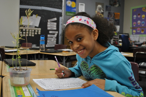 Mya Lang-Martinez, a fourth-grade student at Maplewood Elementary of the Metropolitan School District (MSD) of Wayne Township, Indianapolis reviews the results from her classroom's science experiment focused on growing plants from seeds. (Photo: Business Wire)