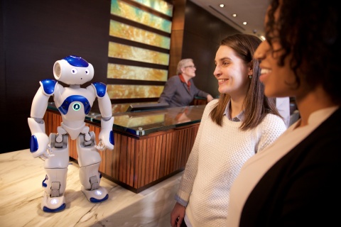 Visitors to the Hilton Hotel in McLean, Va. meet "Connie," a robot concierge named after Conrad Hilton and powered by IBM Watson and WayBlazer. Connie, in pilot testing at the hotel, uses cognitive computing and machine learning to answer questions posed in natural language about the hotel, local tourist attractions and restaurants -- while learning with each interaction. (Photo: Business Wire)