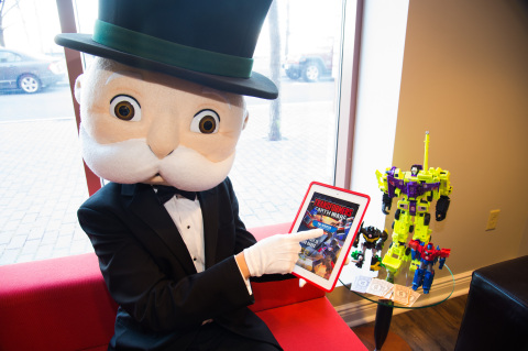 MR. MONOPOLY takes a break with TRANSFORMERS figures and signs up to play the new TRANSFORMERS: EARTH WARS mobile game from Backflip Studios in celebration of the MONOPOLY EMPIRE game and World MONOPOLY Day on March 19, 2016. (Photo: Business Wire)