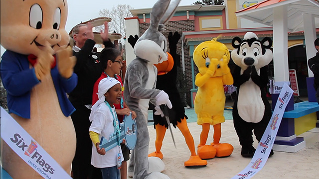 Six Flags Over Georgia and Make-A-Wish Georgia have partnered to name 7-year-old Symeon Honorary Park President For a Day at Six Flags Over Georgia. Symeon was presented with the Key to Six Flags, while acting as Honorary Park President. He shadowed Kaetzel throughout the day, talked with guests, answered questions and brought smiles to all.