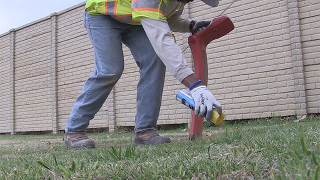 Atmos Energy employee demonstrates the proper way to safely locate and mark underground natural gas pipelines.