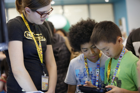 In this photo provided by Nintendo of America, kids work with Nintendo game expert Katie Casper to create their own Super Mario Bros.-themed level in the Super Mario Maker game for the Wii U console. On March 30, Nintendo hosted a workshop at The Mix space at San Francisco Public Library's Main Library location in Downtown San Francisco that taught kids the basics of video game level design. (Alison Yin/AP Images for Nintendo of America)