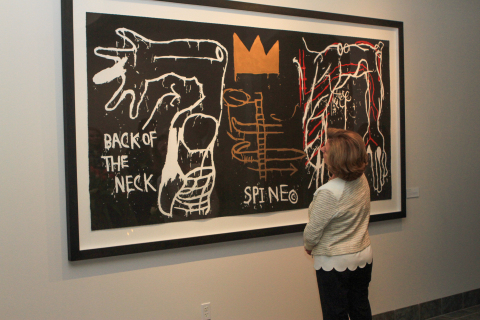 Jann Shoals, the patient experience director at Willamette Dental Group, views Jean-Michel Basquiat's "The Back of the Neck" at the cultural arts initiative event at the company's headquarters in Hillsboro, Ore. March 28 (Photo: Business Wire).