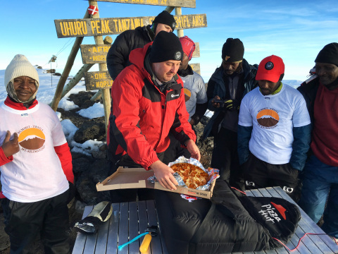 General Manager of Pizza Hut Africa, Randall Blackford, a team of Pizza Hut employees and several professional guides, hiked for six days to the top of Mt. Kilimanjaro to set the Guinness World Records(R) title for the highest altitude pizza delivery on land at a height of 19,341 feet in recognition of Pizza Hut entering its 100th country. (Photo: Business Wire)
