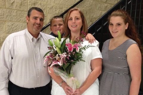 Shannon Morelli (center), Director of Quality Services for Watercrest Senior Living Group, Celebrates Earning her RN License and Associate Nursing Degree with her husband, Mike and children, Mikey and Ammie.