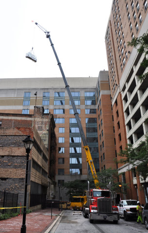 A Crane Hoists One of The Energy Efficient Chillers Up To The Penthouse of The City Crescent Building. (Photo: Business Wire)