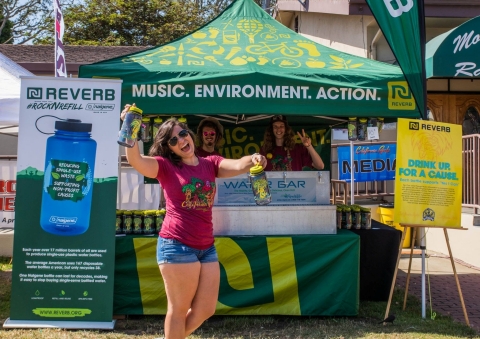 A concertgoer picks up her #rocknrefill Nalgene bottle at the 2016 CaliRoots Festival in late May. This summer Nalgene and REVERB have created custom bottles to be purchased by donation on-site at select outdoor concerts and festivals to raise awareness and reduce waste by refilling reusable water bottles. Donations are expected to raise a minimum of $500,000 for environmental and social causes, and divert as many, if not more, single-use bottles from landfills. (Photo: Business Wire).