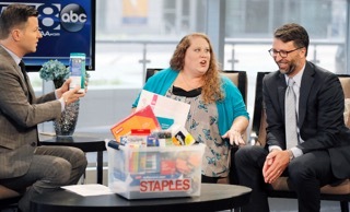 WFAA-TV’s Midday News with host Ron Corning, left, looks on as Bill Durling, VP, Global Communications for Staples, right, presents Jennifer Hatcher, a teacher at W. E. Greiner Exploratory Arts Academy in Dallas, center, with a package of school supplies for her students, courtesy of Staples, during the stations broadcast, Tuesday, July 19, 2016, at WFAA's studios in Dallas, Texas. Durling announced that Staples is funding all teacher projects for Dallas, totaling $185,155, including Mrs. Hatcher’s, currently active on DonorsChoose.org – a charity that has funded more than 700,000 classroom projects and impacted more than 18 million students across the U.S. Continuing its long-standing commitment to support education through its #StaplesforStudents program, Staples teamed up with global superstar Katy Perry earlier this year to announce a $1 million donation to DonorsChoose.org. (Brandon Wade/AP Images for Staples)