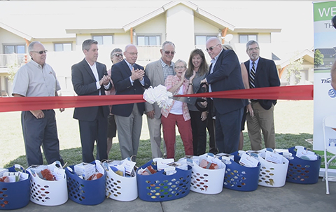 Community leaders, investment partners and new residents celebrated the completion of The Springs II in McCall, bringing 36 new homes to the region, helping address the need for more affordable housing. Optum Idaho was the largest investor, providing $5.5 million of the $7.2 million community developed by The Housing Company and Idaho Housing Finance Association (IHFA). L to R: Joe Rausch, Wright Brothers Construction; Brian Windley, Enterprise Community Investment; Gerald Hunter, president and executive director, IHFA; Valley County Commissioner Bill Willey; Jackie Aymon, mayor, City of McCall; Georganne Benjamin, executive director, Optum Idaho; Douglas Peterson, director, The Housing Company (Video: Chad Case).