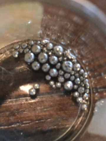 This photo depicts recovered platinum beads—99% pure—from dozens of El Capitan ore concentrate samples tested using a new recovery process that will be used at the production plant currently in development. (Photo: Business Wire)