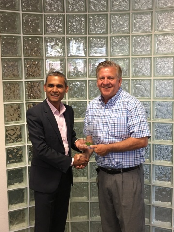 Quest President and CEO, Tim Burke (right) receives the VCSP Platinum plaque from Sanjay Robert (left), Veeam Territory Manager, Veeam Cloud & Service Providers - NW US & Canada West. (Photo: Business Wire)