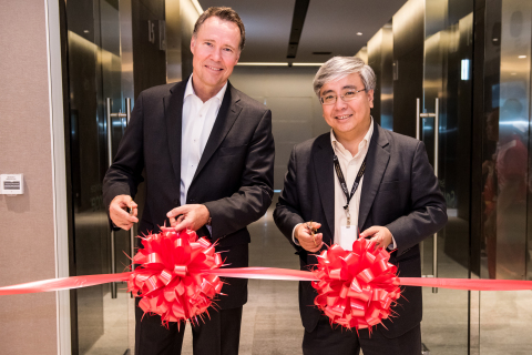 ServiceSource Chief Operating Officer Brian Delaney and Vice President of Managed Services for ServiceSource's APJ Region cut the ceremonial ribbon to celebrate the grand opening of the company's new Singapore office. (Photo: Business Wire)