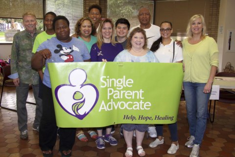 Single Parent Advocate volunteers hand out back to school backpacks and Dallas's MLK Center. (Photo: Business Wire)