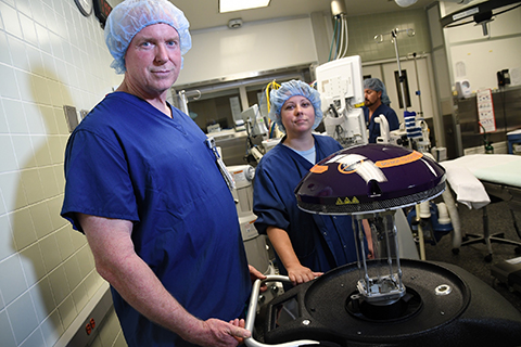 Sharp Coronado Hospital has deployed a Xenex Germ-Zapping Robot to destroy germs and bacteria lurking in the hospital that can pose a risk to patient safety. Pictured with the robot are Stephen Decker, general manager of environmental services, and Lindsay Schimpf, RN, CCRN, infection preventionist Sharp Coronado Hospital. (Photo: Business Wire)