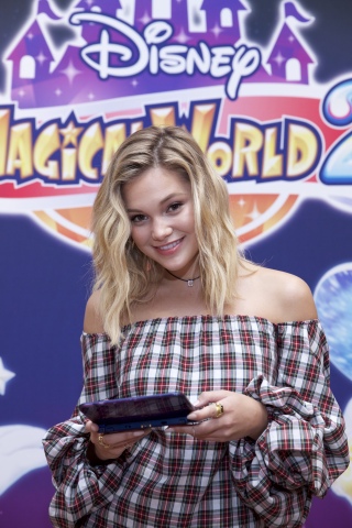 In this photo provided by Nintendo of America, Hollywood Records recording artist Olivia Holt explores the Kingdom of Arendelle in the upcoming Disney Magical World 2 game, launching exclusively for the Nintendo 3DS family of systems on Oct. 14. In the game, players can immerse themselves in the magic of six Disney-themed worlds.