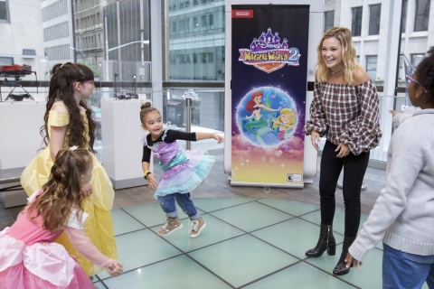 In this photo provided by Nintendo of America, Oliva Holt has a first dance with young fans at the Enchanted Ball Event at Nintendo NY to celebrate the upcoming launch of the Disney Magical World 2 game for the Nintendo 3DS family of systems on Oct. 14.