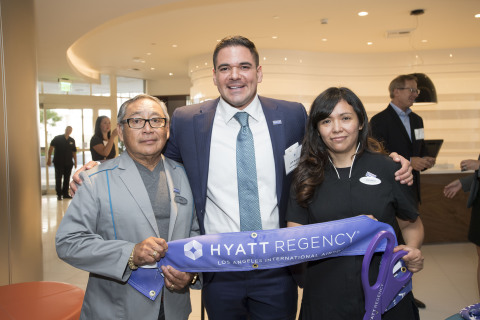 A ribbon cutting ceremony marks the brand transition of The Concourse Hotel at Los Angeles Airport, a Hyatt affiliated hotel, to Hyatt Regency Los Angeles International Airport. Shown from left to right are Victor Estrella, the longest tenured employee who has worked at the hotel for 37 years, Jeff Rostek, the hotel's managing director, and Carolina Barrera, the most recently hired employee. (Photo: Business Wire)