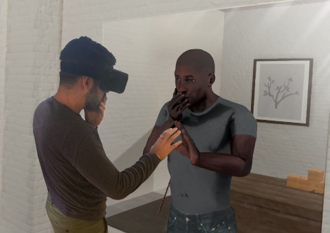 A virtual reality user looks in a virtual mirror and sees himself as a physically different person in a VR program, designed by startup company SPACES, that has the potential to reduce the impact of implicit bias, the measurable, objective attitudes and stereotypes that everyone carries. SPACES introduced the new implicit bias VR program today (Oct. 10, 2016). SPACES has created the implicit bias VR program with academic and scientific research, law-enforcement and corporate training in mind. (Photo: Business Wire)