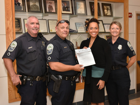 Edward Stapleton, Ronald Eicke, and Denise Randles of the Herndon Police Department with Alexzandra Shade, Executive Director of the NWFCU Foundation (Photo: Business Wire)