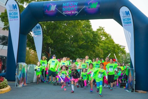 Runners of all ages take off down the course at the NWFCU Foundation’s 2nd annual Neon Night Glow Run (Photo: Business Wire)