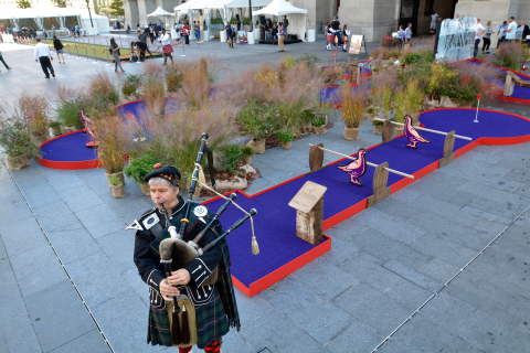 Bagpiper Charles Rutan of Philadelphia plays the pipes next to a miniature golf course set up as part of "the world's largest putting green" event at Dilworth Park at City Hall Tuesday. A 104 foot and 2 inch putting green  at Dilworth at which former Eagle Hollis Thomas helped set a Guinness World Record was part of the event. The event was sponsored by The Famous Grouse, Scotland's number one Scotch. (Photo: Mark C. Psoras)