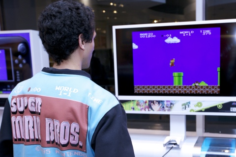 In this photo provided by Nintendo of America, a consumer plays Super Mario Bros., which is one of 30 classic NES games built into the Nintendo Entertainment System: NES Classic Edition system at an event at Nintendo NY on Nov. 10, 2016