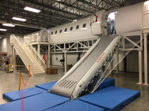 Republic Airways' new 170/175 Cabin Trainer, a 15-ton, 60-foot-long facility housed in the Indianapolis Training Center, is the newest and most sophisticated such module in the regional airline industry today. In addition to a cockpit with working seats, windows and oxygen masks, the unit has a galley, two-class seating, a lavatory, working cabin doors, an emergency escape slide, a smoke-generating machine and audio devices in the floor to replicate flight sounds. The facility was built by RP Aero Systems of England and delivered in October. Republic will begin using the new facility to train crewmembers in January 2017. (Photo: Business Wire)