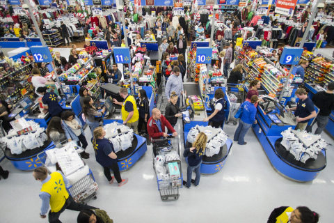 Walmart customers check out after shopping the store's Black Friday event. (Photo: Business Wire)