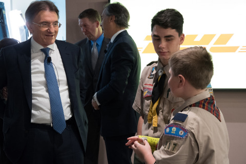 DHL Express Global CEO Ken Allen congratulates two Baltimore Area Boy Scouts for their efforts in helping to raise funds to provide 24 pallets of popcorn being shipped by DHL Express to U.S. troops in Afghanistan, Kuwait and Djibouti. (Photo: Business Wire)