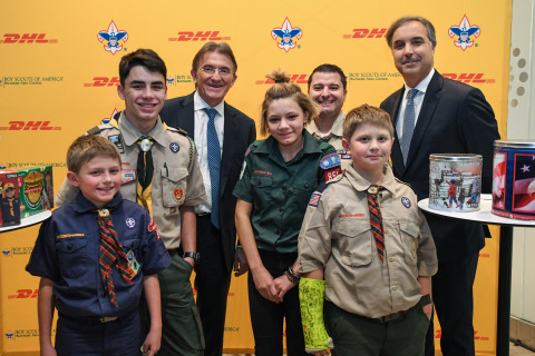 DHL Express Global CEO Ken Allen, Baltimore Area Council COO Manny Fonseca and DHL Express Americas CEO Mike Parra, (left to right), recognized four Boy Scouts, each representing one of the four levels of the Boy Scout program, for their efforts in helping to raise funds to provide 24 pallets of popcorn being shipped by DHL Express to U.S. troops in Afghanistan, Kuwait and Djibouti. (Photo: Business Wire)