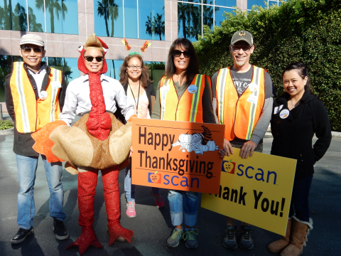 Volunteers help direct traffic at SCAN's 24th annual Thanksgiving meal delivery event in Long Beach. (Photo: Business Wire)