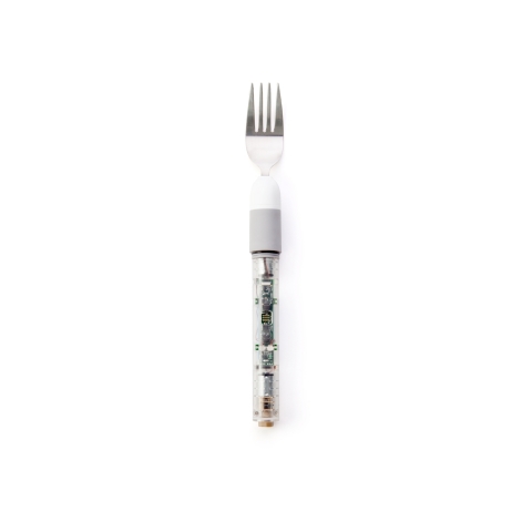 Liftware Level (shown with the fork attachment) is able to recognize hand movement and intelligently adjust the angle of the utensil so users can eat without spilling. (Photo: Business Wire)