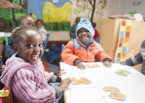 Young children from an informal settlement of Kenya attend a daycare center supported by Kidogo. (Photo credit: Joop Rubens)