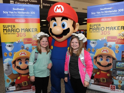 In this photo provided by Nintendo of America, passengers arriving at Los Angeles International Airport are greeted by Mario as they disembark their Southwest Airlines flight from Dallas Love Field on Wednesday, Dec. 14. Pictured, from left to right, are Marley H. of Fort Worth, Texas, and Morgan H. of Fort Worth, Texas. In the air, passengers received New Nintendo 3DS XL systems and a voucher to download Super Mario Maker for Nintendo 3DS from Nintendo eShop. From Dec. 16, 2016 through Jan. 14, 2017, everyone can get in on the fun and enter the Say Yes to Nintendo 3DS sweepstakes for a chance to win a trip to NYC and Nintendo prize packages. (Photo: Business Wire)