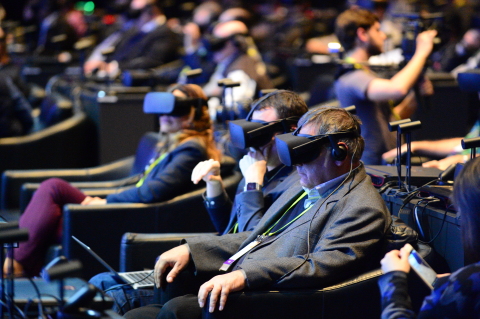Audience members use virtual reality headsets to experience a series of travel, work and play situat ... 